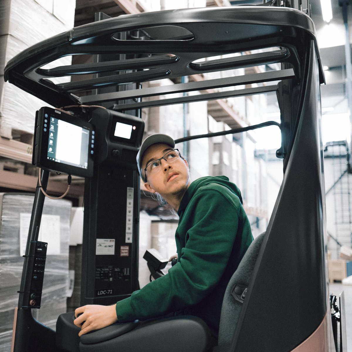 Trainee driving a forklift truck in a warehouse