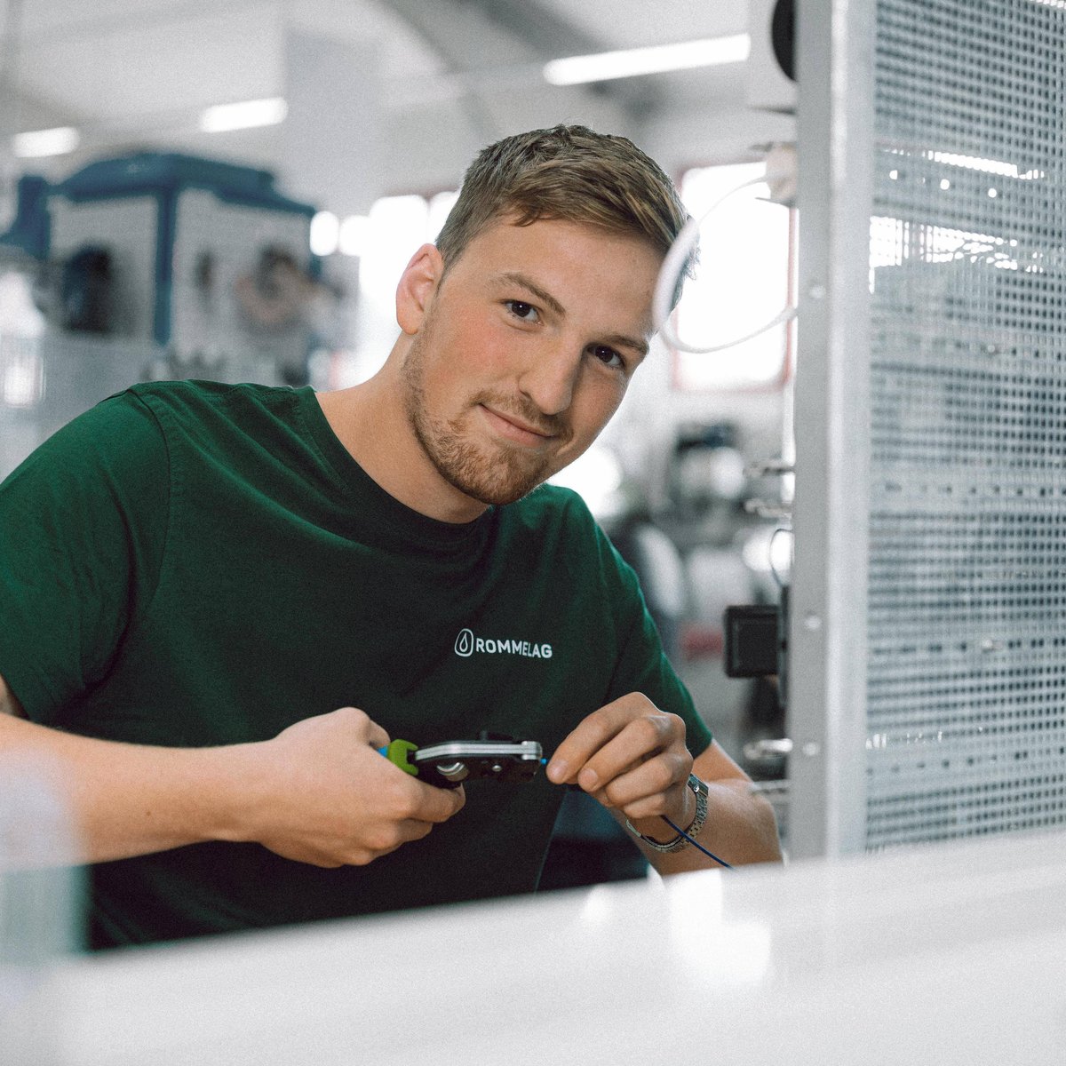Apprentice at work with insulating pliers