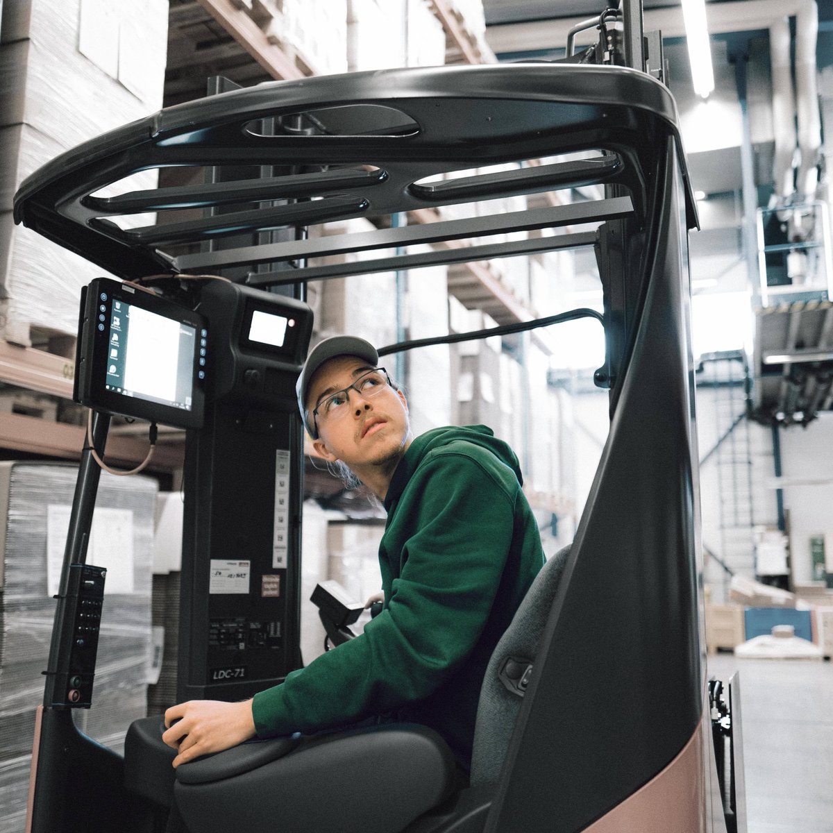 Trainee driving a forklift truck in a warehouse 